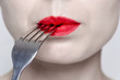 © grufnar - close up of a woman's lips with red lipstick and a fork in the mouth
