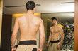 © theartofphoto - Young Man Admiring His Muscles in Mirror