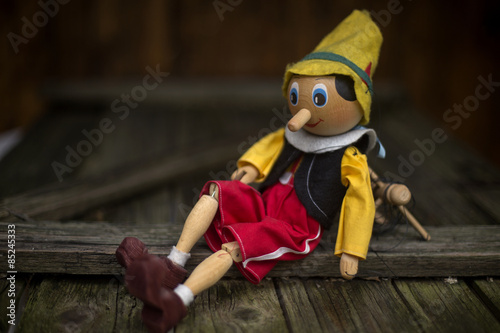 Old wooden pinocchio marionette toy .