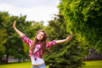 Wall Mural - young happy woman in the park