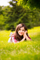 Wall Mural - girl lying on the grass in the park