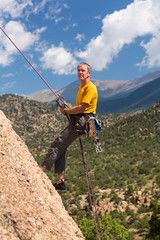 Senior man rappelling in Colorado