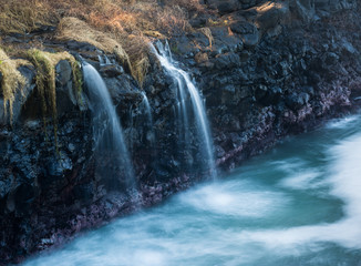 Wall Mural - Waterfall flows into sea at Queens Bath Kauai