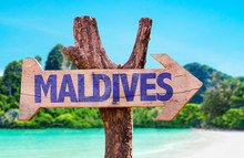 Maldives Wooden Sign With Beach Background