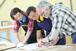 Young people in carpentry course with teacher