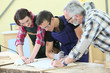 © goodluz - Young people in carpentry course with teacher