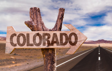 Wall Mural - Colorado wooden sign with desert road background