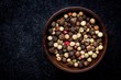 peppercorns in a wooden bowl