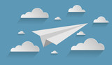 Paper plane flying in the clouds