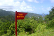 Wooden Trail Entrance Sign. Atlantic Ocean coastline, Dominica, Caribbean islands