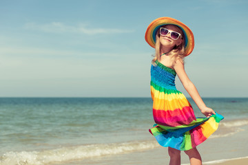 Wall Mural - Little girl  standing on the beach