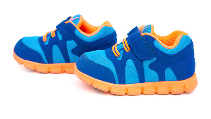 Wall Mural - pair of blue sporty shoes for kid on white