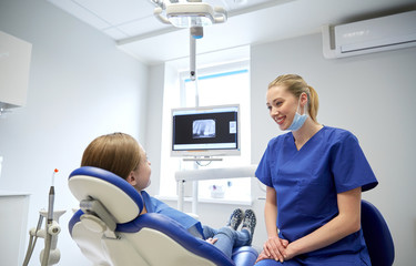 Sticker - happy female dentist with patient girl at clinic