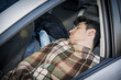 © theartofphoto - Young handosme man sleeping in his car