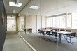 © Westend61 - Corridor and modern conference room separated by glass pane
