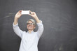 © Westend61 - Mature woman at blackboard taking selfie