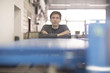© Westend61 - Portrait of confident technician leaning on machine