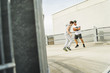 © Westend61 - Two young men playing with football on parking level
