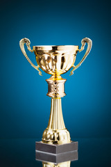 Wall Mural - gold cup trophy on blue background