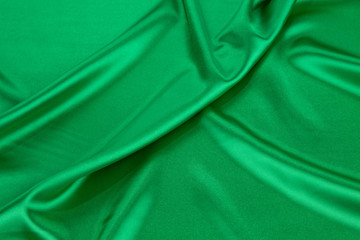 Green silk cloth with some soft folds.