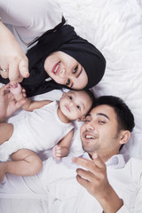 Wall Mural - Closeup of happy parents and baby boy