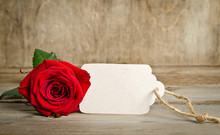 Red Rose With Empty Tag For You Text On Wooden Background
