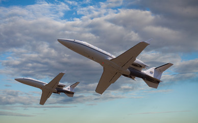 Two private jets flying close to each other