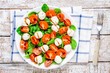 salad of mozzarella, cherry tomatoes and spinach with balsamic sauce