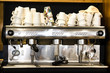 Coffee machine with a pile of cups at the counter top of the cafeteria