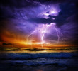 canvas print picture - lightning and storm on sea to the sunset - bad weather
