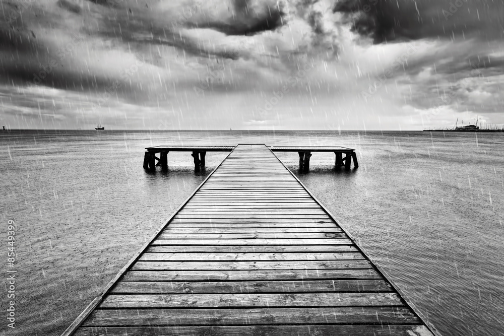 Old jetty, pier on the sea. Black and white, rain. - obrazy, fototapety, plakaty 