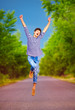 © Olesia Bilkei - happy young boy jumping on summer road