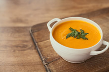 Carrot Cream Soup On The Wood Table