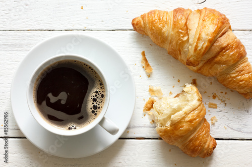 Fotografie, Obraz Croissants and coffee in cup on rustic white wood, from above.