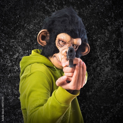 Monkey man shooting with a pistol Stock Photo Adobe Stock