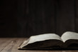 © 4Max - Image of a book on wooden background in a dark space