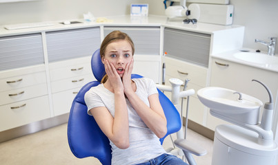 Wall Mural - scared and terrified patient girl at dental clinic