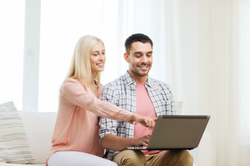 Sticker - smiling happy couple with laptop computer at home