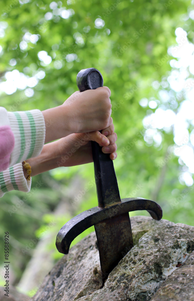 excalibur the famous sword in the stone of king Arthur in the fo Stock ...