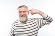 © kostyha - portrait of an elderly man with a beard finger near head