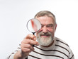 © kostyha - Old man with a beard with a magnifying glass