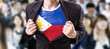 © gustavofrazao - Businessman stretching suit with Philippines Flag