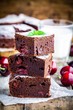 pieces of homemade chocolate brownie dessert with cherries