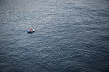 Lonely Rowboat On A Large Expanse Of Sea