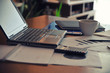 © michalchm89 - Workplace with open laptop with black screen and business documents with charts growth and pen.- workplace