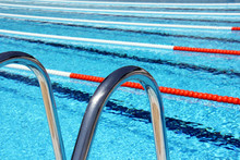 View Of Lane Rope Through A Pool Ladder In An Outside Olympic Pool.