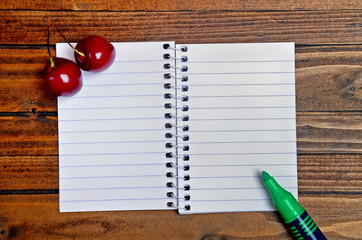 Wall Mural - Empty notebook with cherry on table