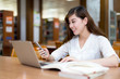 © zhu difeng - Asian beautiful female student study in library with laptop