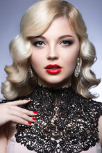 Beautiful Blonde In A Hollywood Manner With Curls, Red Lips And Lace Dress. Beauty Face. Picture Taken In The Studio On A White Background.