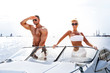 Elegant beautiful couple on a boat in a swim wear